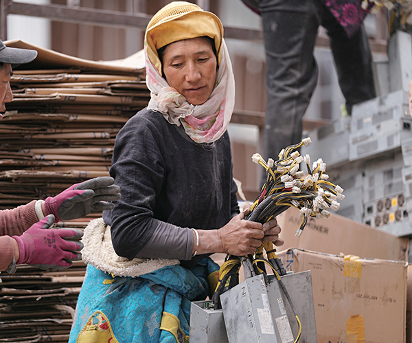 Woman carrying bitcoin mining asics machines, May 2021