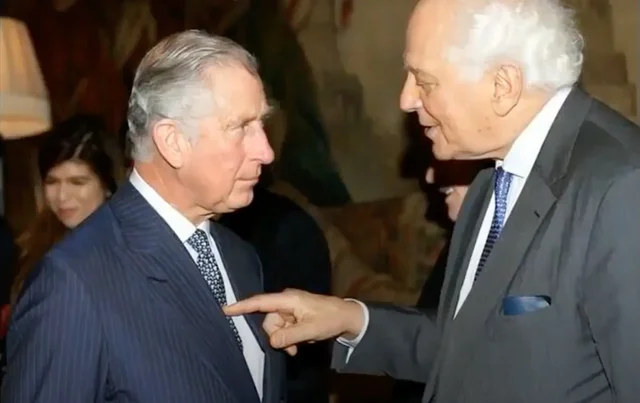 King Charles, heir to the British throne, getting poked on the chest by Evelyn de Rothschild back when he was Prince Charles